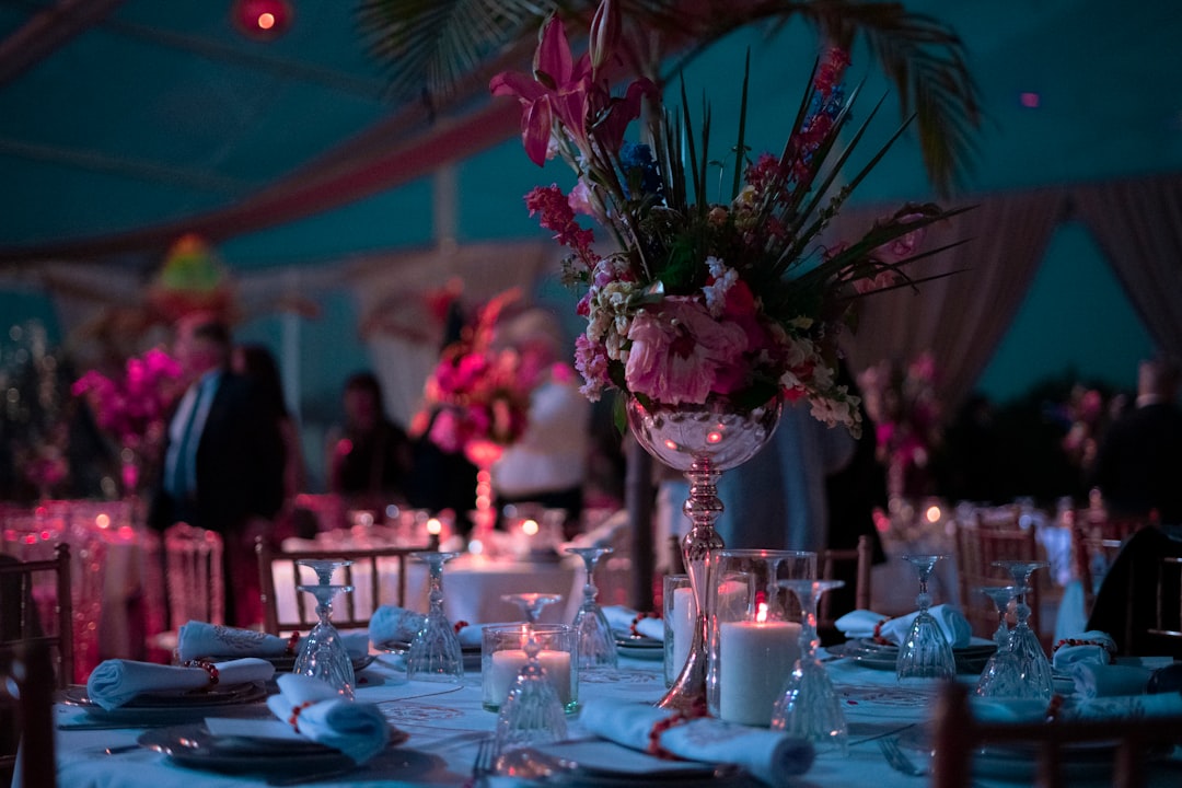 a-table-with-a-vase-of-flowers-and-candles-on-it-owepht9a-90